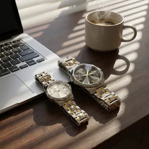 Elegant pair of quartz watches with dual calendar and gold-toned steel link bands