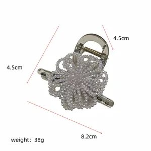 Detail view of 8.2cm metal spring hair claw with beaded floral design dimensions