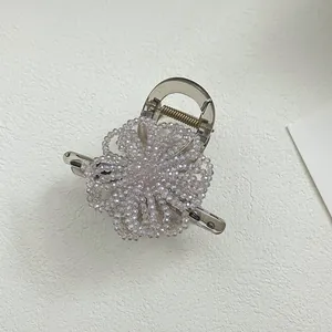 Detailed macro view of a translucent smoke gray hair claw with purple beaded flower