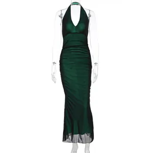 Detail view of deep green halter neck mesh dress with ruching and fish-tail hemline