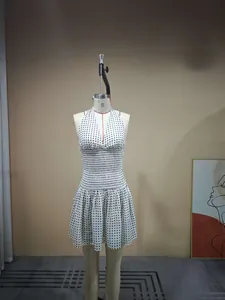 Detailed view of the smocked elastic waist and polka dot pattern on the halter dress