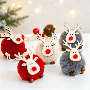 Detail of plush Christmas reindeer ornaments with wooden heads and soft pompom bodies