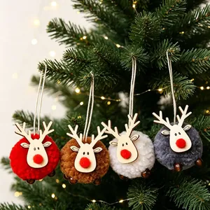 Set of four plush reindeer Christmas ornaments in red, white, coffee, and grey on a tree