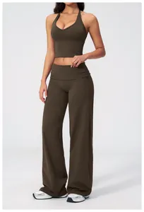 Detail of high-waisted wide leg pants and V-neck cropped yoga top in olive green