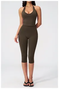 Detail view of olive green V-neck halter yoga top and high waist cropped leggings