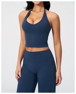 Detail of navy blue V-neck halter yoga top and high-waisted leggings set in studio