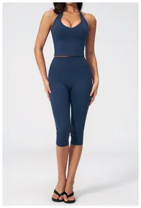 Front view of navy blue halter yoga sports bra and high-waist capri leggings set