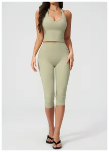 Close-up of the halter neck cropped tank top and high waist leggings in sage green
