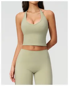 Detail of sage green yoga set showing high-waisted leggings and halter neck sports bra