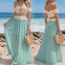 Detail of crochet halter top with lace-up front and bohemian mint green maxi skirt