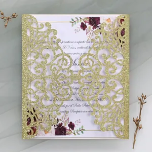 Intricate laser-cut gold glitter wedding invitation with elegant rose floral inner card