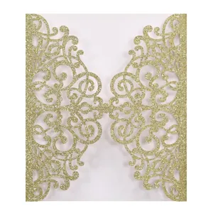 Macro view of gold glitter laser-cut invitation sleeve with ornate hollow floral design