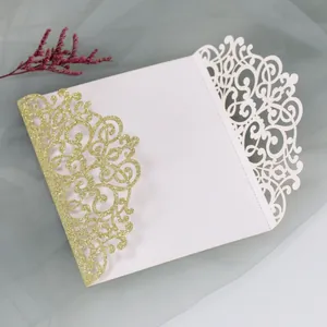 Detail of laser-cut wedding invitation with gold glitter finish and hollow carving
