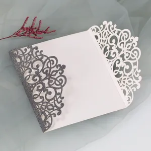Close-up of laser-cut hollow invitation with glitter finish and elegant floral details