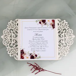 Detail view of laser-cut wedding invitation with elegant floral printed inner sheet