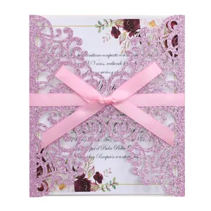 Pink laser cut glitter invitation card with floral insert and satin ribbon bow
