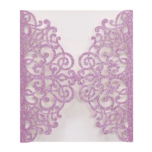 Close-up of laser-cut glitter paper invitation cover with intricate floral patterns