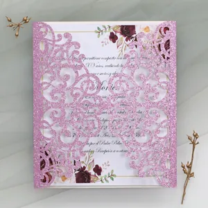 Detail of pink glitter laser-cut invitation with floral card for Quinceañera event