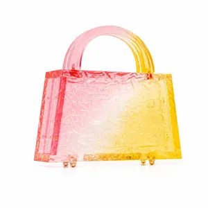 Detailed close-up of pink-yellow gradient acrylic handbag with ice-crushed texture