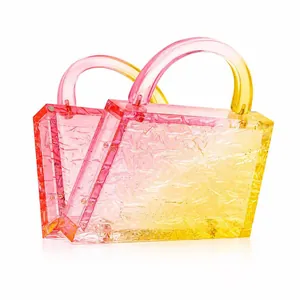 Detail of gradient pink and yellow acrylic handbag with crushed ice crystal texture