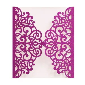 Macro detail of laser cut glitter cardstock invitation with purple scroll patterns
