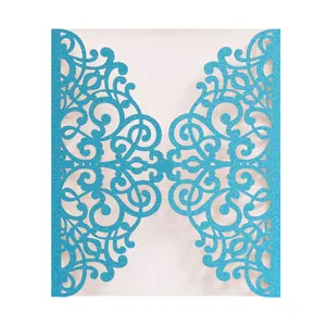 Close-up of laser-cut light blue glitter invitation card with floral hollow pattern