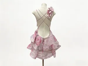 Detail view of the backless floral dress with cross straps and layered ruffles