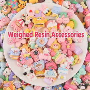 Close-up of mixed colorful acrylic charms featuring cartoon pencils and book designs