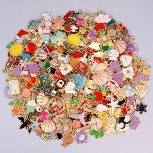 Close-up of mixed colorful enamel charms including fruits and animals for DIY crafts