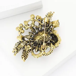 Detail view of the vintage gold alloy brooch back showing pin clasp and hollow pattern