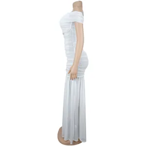 Detail view of the ruched white mesh fabric and off-the-shoulder hem on a long dress