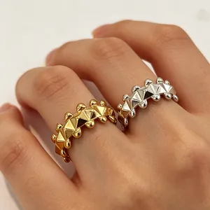Modern adjustable pyramid rivet rings in gold and silver finish on hand