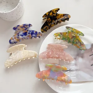 Collection of large acetate hair claws in various colorful marble and tortoiseshell patterns