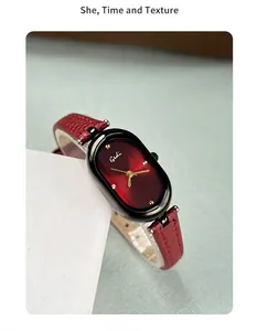 Detail of the elegant red sunray dial and polished oval case of this vintage quartz watch