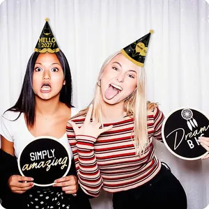 Close-up of Hello 2027 party hats and hand-held signs for New Year celebrations