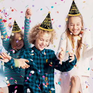 Close-up of three black and gold Happy New Year party hats with festive sequin trim