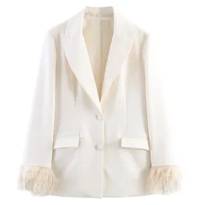 Detail of white blazer with luxury feather cuffs and classic notched lapel design