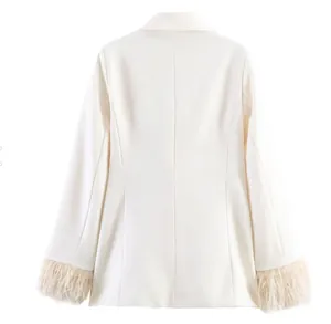 Detailed back view of off-white blazer with elegant feather trim on cuffs