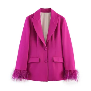 Detail of fuchsia blazer with elegant feather cuffs and peak lapel for women