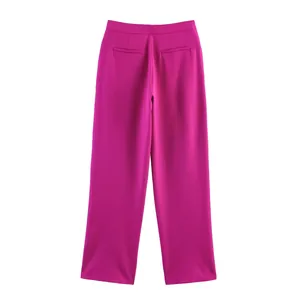 Detail of vibrant rose pink high-waisted suit trousers with sleek rear welt pockets