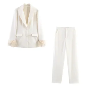 Elegant white women's two-piece suit with feathered cuffs and straight-leg trousers