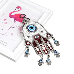 Lucky Hamsa Hand and Evil Eye metal pendant with elephant charm and blue enamel accents