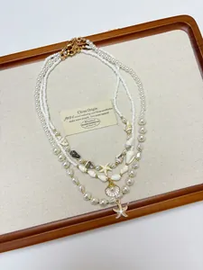 Detailed macro of multi-layer ocean necklace with seashell and starfish pendants