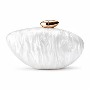 Close-up of white pearlescent acrylic clutch with a polished gold metal clasp detail
