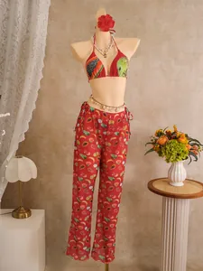 Detailed look at the vibrant fruit print bikini top and high-waisted wide-leg beach pants