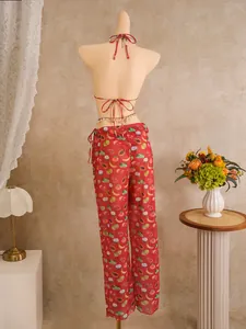 Rear view of vibrant red tropical fruit print beach set with wide-leg pants and halter top