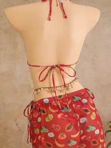 Detail of red tropical fruit print bikini set with golden seashell pendant waist chain