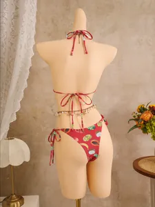 Detail of red bikini back with tropical fruit print and sea shell metal waist chain