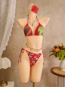 Detail of red bikini with tropical fruit print and side-tie bottoms on mannequin