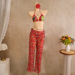 Detail of red tropical fruit print bikini top and matching trousers set for women